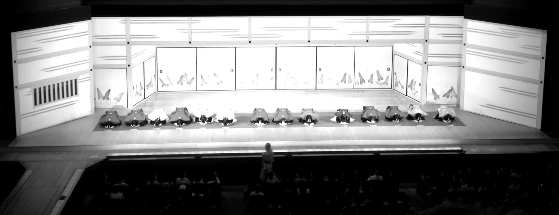 A kabuki stage seen from the auditorium, curtain open and set dressed.